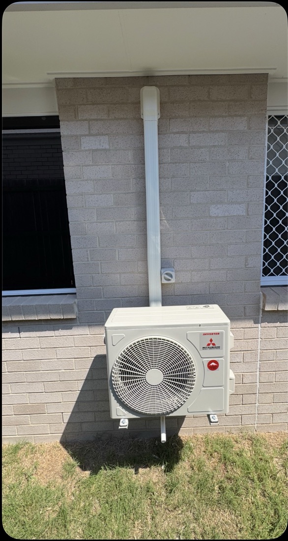 Outdoor unit installed on a brick wall